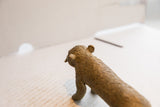 The textured, patterned back and head of the vintage cheetah sculpture seen from above.