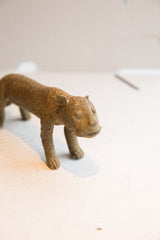 Angled view of the handmade cheetah sculpture's stylized face and textured body.