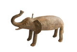 Handmade vintage African elephant sculpture with a textured, earthy patina and raised trunk.