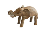 Vintage African elephant sculpture with a rustic, handmade quality and a weathered brown finish.
