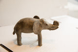 Aged patina and handmade form of a vintage elephant sculpture shown in profile.