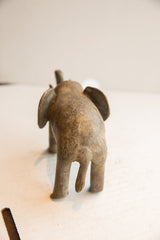 Rear view of the vintage elephant sculpture highlighting its rustic, handmade texture.