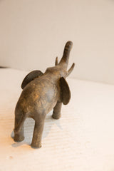 High-angle rear view of the vintage elephant sculpture highlighting its weathered patina.