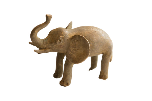 Vintage African elephant sculpture with a rustic handmade texture and aged brown patina.