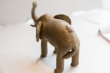 Rear view of the handmade elephant sculpture highlighting its rustic, textured surface.