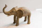 Side profile of the vintage elephant sculpture showing its hand-carved eye and ear.