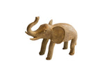 Vintage handmade African elephant sculpture with a textured, earthy-brown finish and raised trunk.