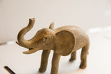 Handmade charm and textured finish on a vintage elephant sculpture's head and raised trunk.
