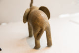 Rear view of the vintage African elephant sculpture with earthy, handmade texture.