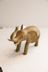 Angled side profile of the vintage elephant sculpture showing its textured finish.