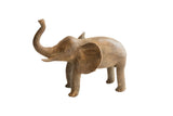 Handmade vintage African elephant sculpture with an aged, earthy patina and raised trunk.