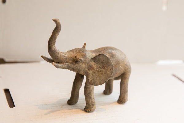 Three-quarter view of a vintage African elephant with a textured, aged surface.