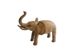 Vintage African elephant sculpture with a rustic, textured brown finish and a raised trunk.