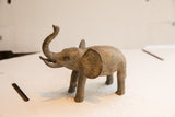 Three-quarter view of the vintage elephant sculpture's textured, handmade finish.