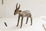 Vintage African antelope sculpture showing its slender profile and charming handmade texture.