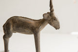 Side view of the handmade antelope sculpture highlighting its aged, textured patina.