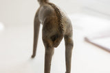 Vintage African antelope sculpture's back, detailing the handmade braided spine and textured patina.