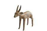 Vintage African antelope sculpture with an earthy patina, spiraled horns, and textured spine.
