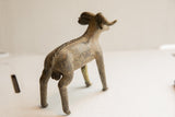 Rear angle of the vintage ram sculpture highlighting its textured spine and weathered patina.