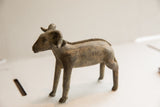 Angled view of the vintage ram sculpture's textured spine and aged patina.