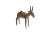 Vintage African antelope sculpture with a rustic handmade texture and dark aged patina.