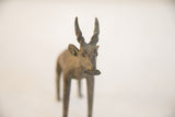 A direct frontal view of the vintage antelope sculpture's textured face.