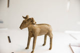 Side view of the vintage handmade ram sculpture showing its rustic, earthen texture.