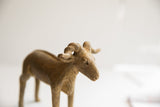 Detailed view of the vintage ram sculpture's face and expressive, curled horns.