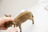 Handmade braided texture running along the spine of the vintage ram sculpture.