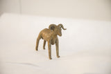 Angled view of the vintage African ram sculpture's rustic handmade form.