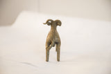 Rear view of the handmade African ram sculpture with textured spine and tail.