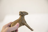 Handmade African ram sculpture held to show its scale and side profile.
