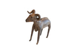Vintage African ram sculpture with a rustic brown patina and stylized curved horns.