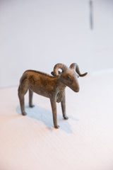 Full view of the vintage African ram sculpture showing its aged, textured finish.