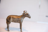 Handmade vintage African ram sculpture with a textured spine and aged patina.