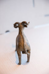 Textured spine detail and small tail on the back of a vintage ram sculpture.