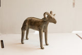 Vintage ram sculpture seen in profile, showing its curved horns and dark, weathered patina.