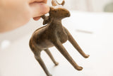Vintage African ram sculpture held in hand to illustrate its scale.