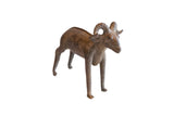Vintage African ram sculpture with a mottled brown patina and distinct, curled horns.