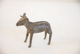 Profile view of the vintage African ram showing its textured, handmade form and patina.