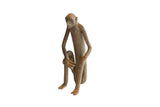 Vintage African sculpture of a sitting monkey with a banana, featuring an elongated form and matte finish.