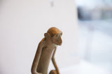 Detailed profile of the vintage African monkey sculpture's expressive face and textured finish.