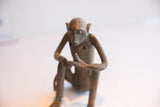 Expressive face and handmade texture of a vintage African monkey sculpture.