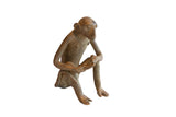 Vintage handmade African monkey sculpture in a sitting pose with a weathered brown patina.
