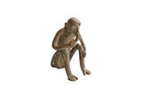 Vintage African monkey figurine seated with a weathered, handmade texture.