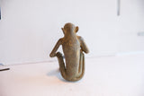 Rear view of the vintage African monkey figurine showing its sculpted back and form.