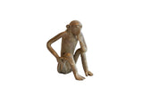 Vintage African sitting monkey figurine in a thoughtful pose with a bronze patina.