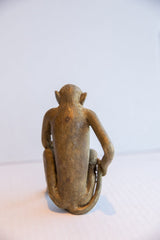 Vintage African monkey figurine seen from the back, detailing its handmade form and aged patina.