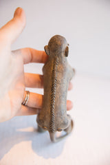 Rear view of the vintage monkey figurine showing the hand-carved spine detail.