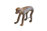 Vintage handmade African monkey figurine with a textured, aged brown patina.